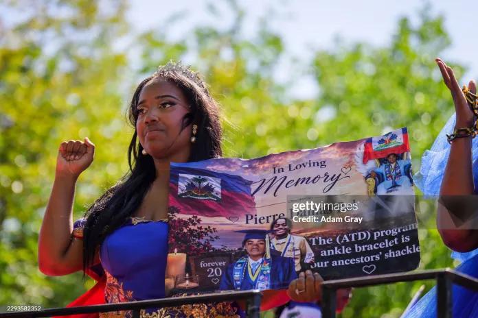 This woman holds a sign about Pierre Damas Bel during the annual West Indian Day Parade on September 7, 2026 in the Brooklyn borough of New York City. 