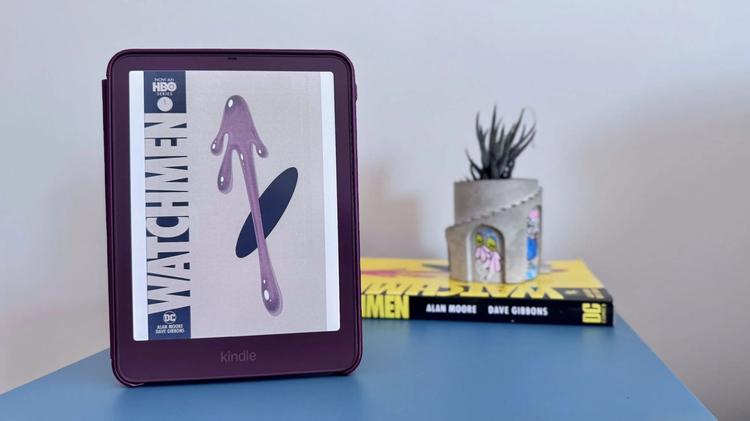 kindle colorsoft with watchmen cover on display and the graphic novel in the background