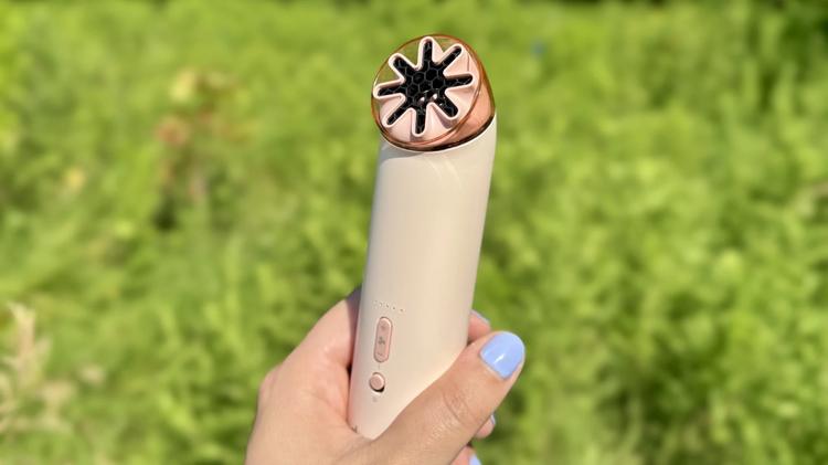 the dyson hushjet mini cool in a woman's hand