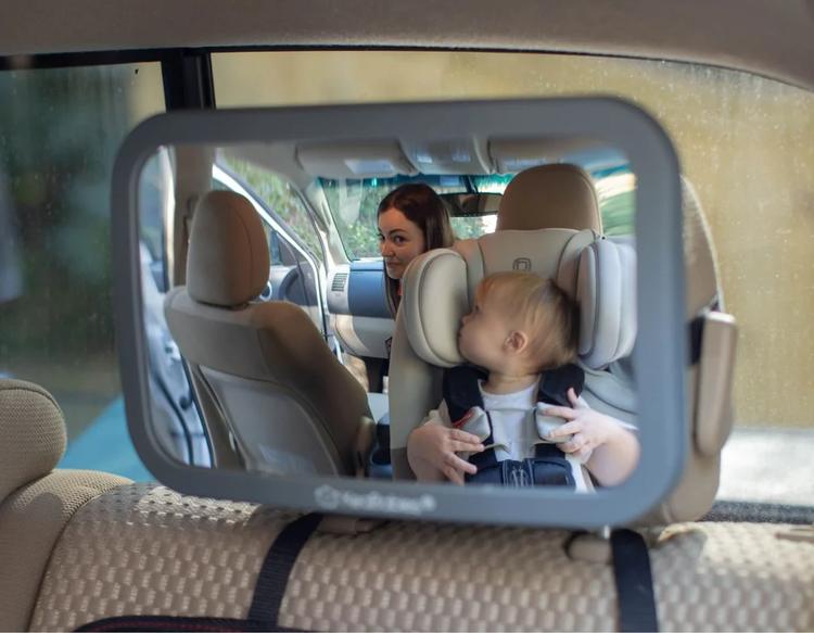 A KeaBabies car seat mirror attached to the headrest for safe travel with a baby.