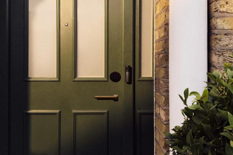 apple video doorbell and smart lock on front door of modern home