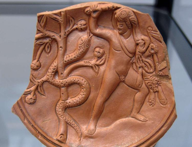 Heracles and Ladon guarding the tree of the golden apples. Roman relief of an oil lamp, late era