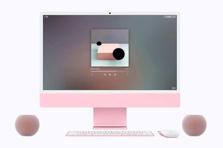 two homepod mini 2 speakers next to an imac