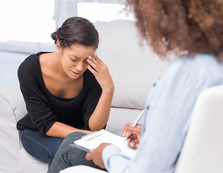 Postpartum mom discussing mood swings and emotional changes with a healthcare provider.