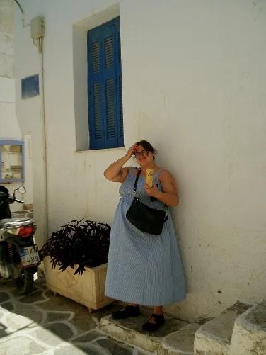 A person standing against a wall