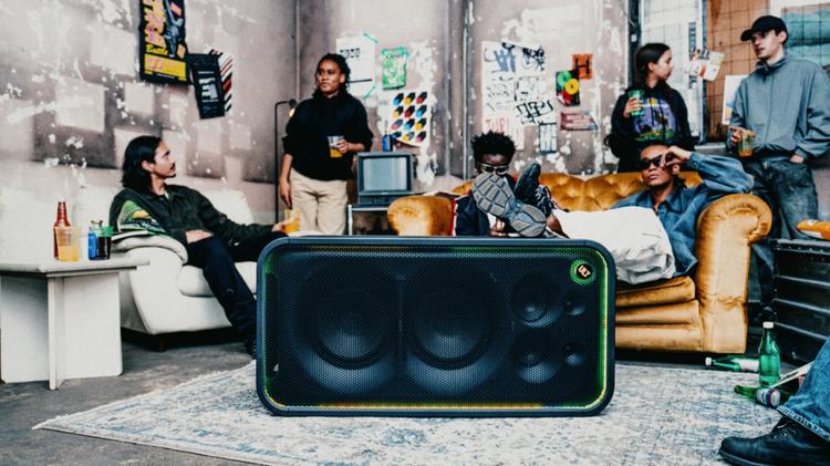 people sitting around the sony ult tower max speaker