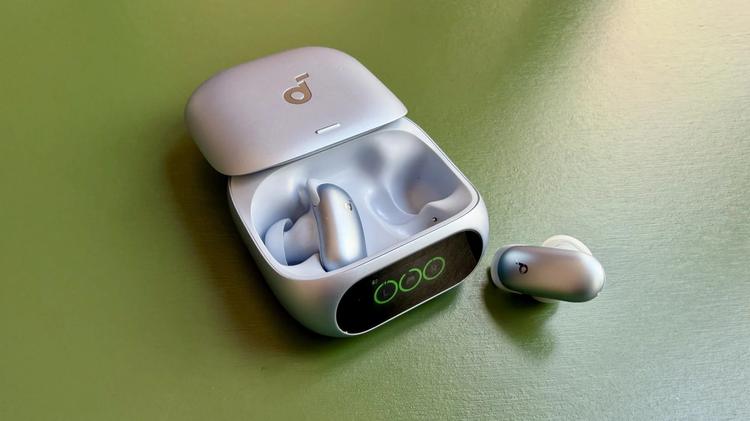blue soundcore liberty 5 pro case and earbuds on green table