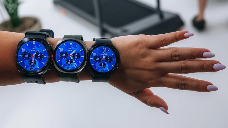 several samsung galaxy watches on a person's wrist