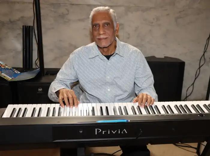 Vincentian musical maestro Dr. Frankie McIntosh plays the keyboard.