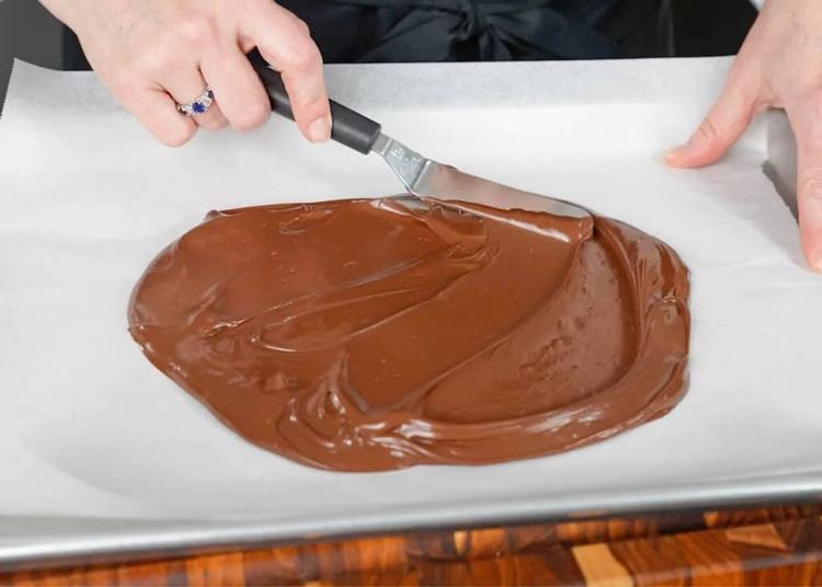 spreading the chocolate across the parchment