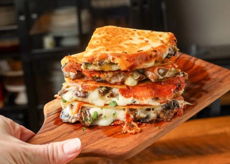 sliced and stacked quesadillas on cutting board