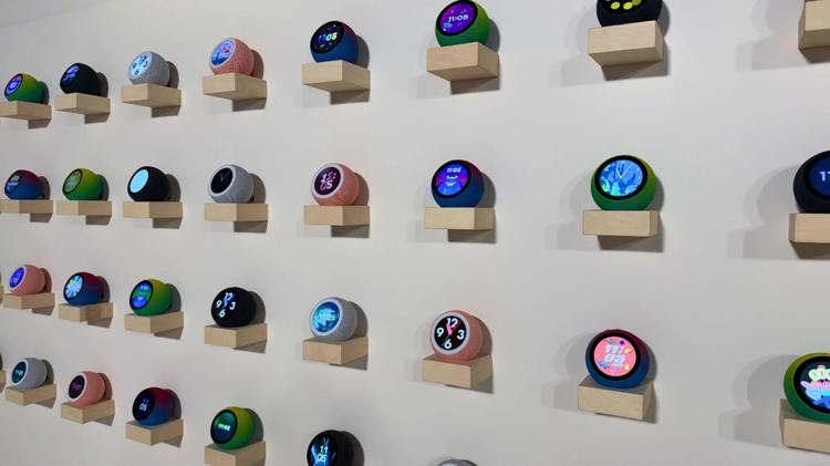 a collection of Echo Time devices on mini shelves on a wall