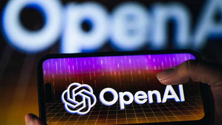 person holds smartphone with openai name and logo on screen