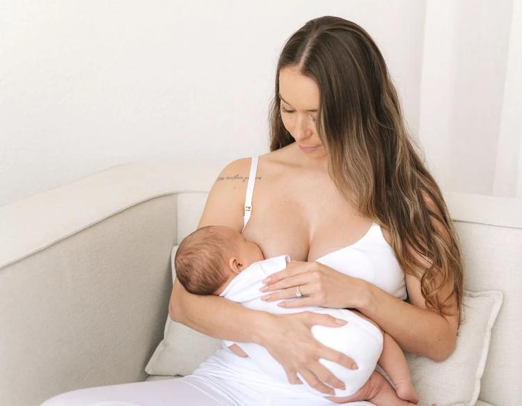 Mom breastfeeding baby while wearing light, breathable clothing in summer