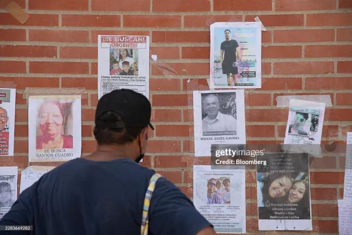 A resident reads flyers for missing people following the June 24 earthquakes in Caraballeda, La Guaira state, Venezuela, on Wednesday, July 1, 2026.