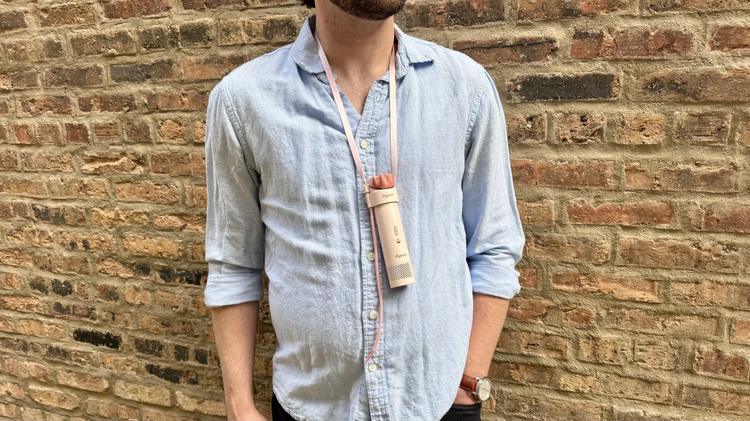 a man wearing the dyson hushjet mini cool around his neck