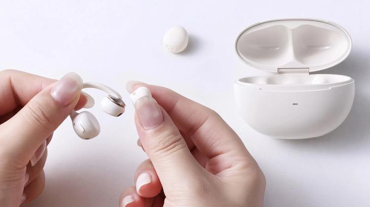 person replacing ear tips on baseus earbuds