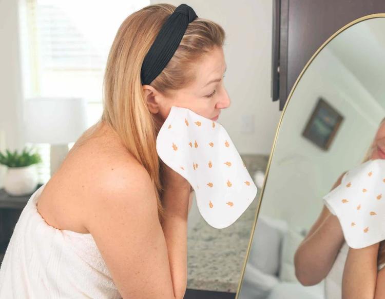 Mom using the Cami Baby Washcloth for both baby care and personal care, a soft multi-use washcloth ideal for gentle cleansing during bath time and daily hygiene routines.