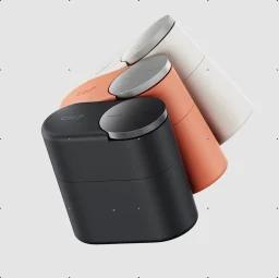 CMF Clip Pro buds in light grey, dark grey, and coral