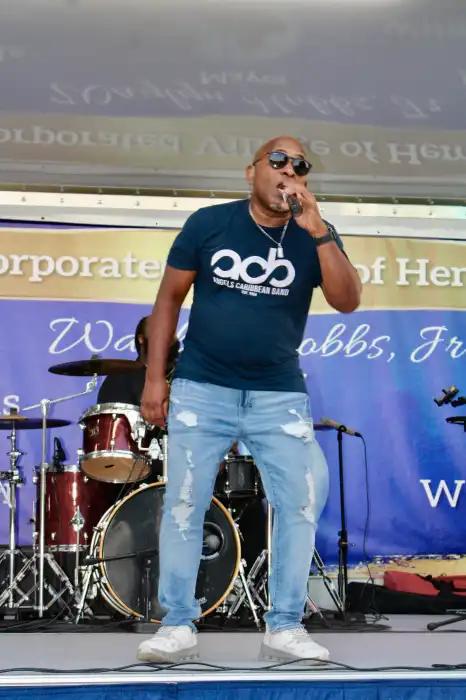Lead male vocalist of the Caribbean Angels Band Dexter M on stage in Denton Green Park, at the 5th Annual Summer concert on July 17.