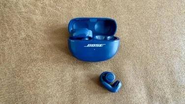 blue bose ultra open earbuds with one earbud in case and one earbud out