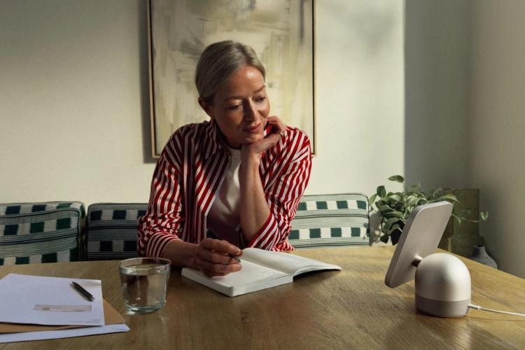 woman using apple homeview smart display on office desk
