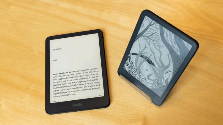 two kindle paperwhite devices on wood surface