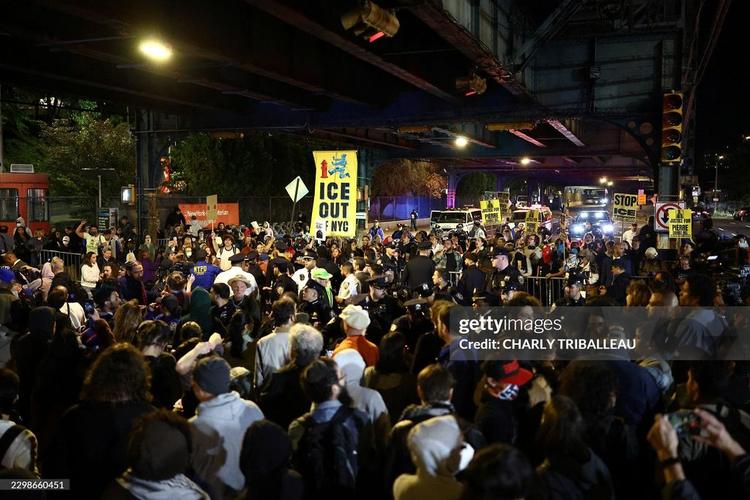 Protesters gather near the scene where a man was shot by an Immigration and Customs Enforcement (ICE) officer during an operation in the Bronx borough of New York City on October 8, 2026, according to local media and police. (Photo by CHARLY TRIBALLEAU / AFP via Getty Images)