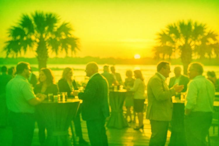 A vibrant outdoor networking event in North Charleston featuring local business members at the golden hour.