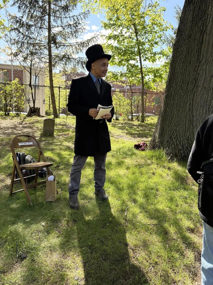 Poet David Mills performs at Maple Grove Cemetery