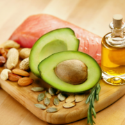 Fresh avocado with salmon, nuts, seeds, oil