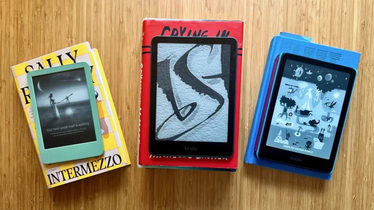 amazon kindle e-readers on piles of books