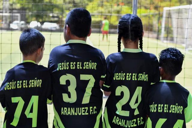 Children wearing soccer jerseys.