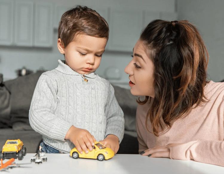 Mother comforting her toddler at home during a morning school transition.