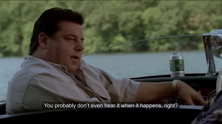 The character Bobby Baccalieri, a man wearing a shirt, sitting on a boat and talking.