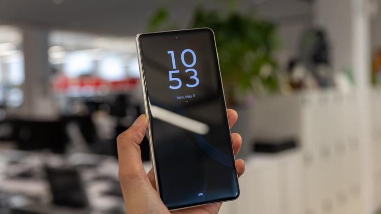 motorola razr fold held in hand in modern office