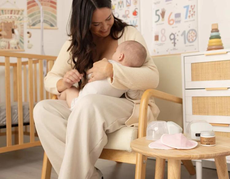 Mom breastfeeding her baby during daytime in a cozy nursery.