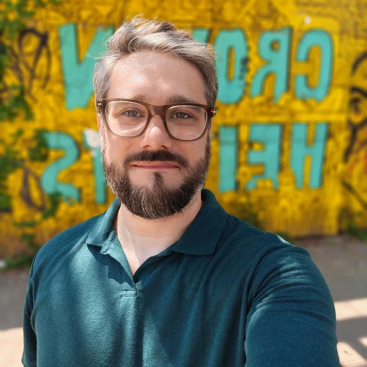 selfie of timothy beck werth with crown heights mural in background