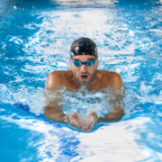 Swimmer performing breaststroke in swimming pool