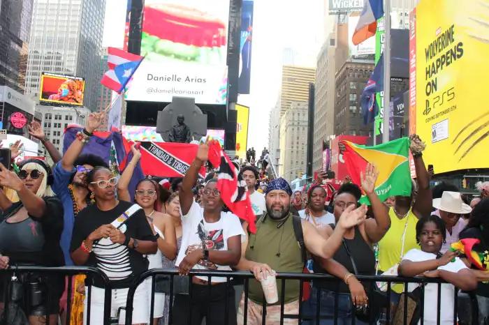 Caribbean flags are seen in the air at Tropicalfete's fifth annual Carnival Pop-Up in Times Square. 