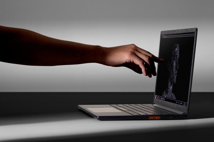 a person touching the screen of the framework laptop 13 pro
