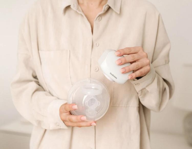 Mom holding a clean KeaBabies Pulse Breast Pump