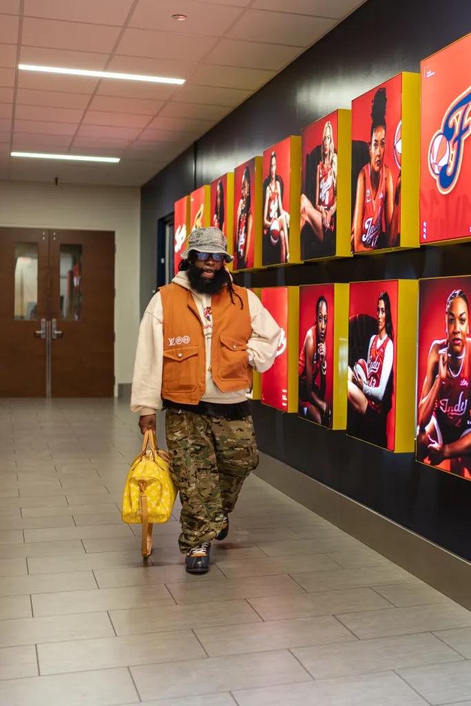 Jas Bell walks past Indiana Fever player displays
