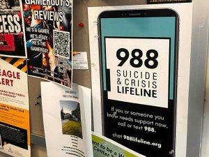 A poster promoting the 988 Suicide & Crisis Lifeline hangs on a bulletin board at The University of Southern Mississippi.