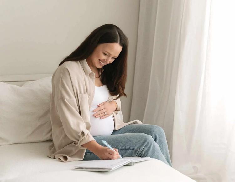 Mom making a to-do list to organize household tasks, planning and prioritizing daily responsibilities for a more structured and efficient home routine.