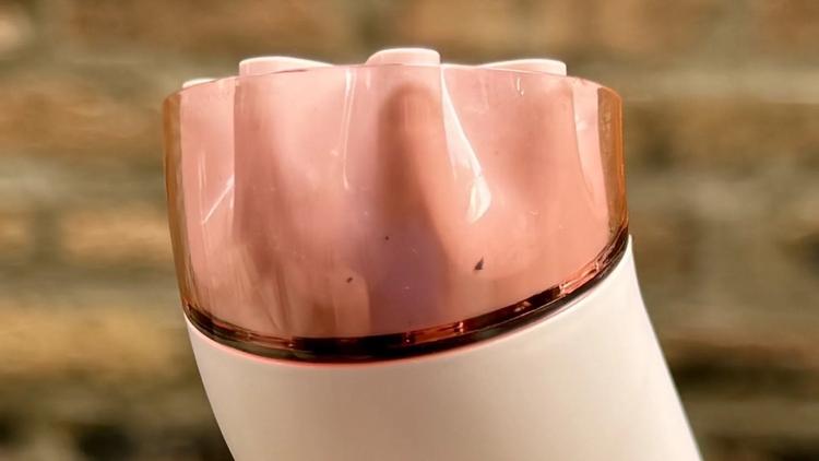 a close-up of dirt trapped in the dyson hushjet mini cool's nozzle