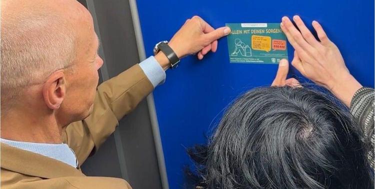  Minister Schwarz mit einer Visitenkarte mit der Aufschrift: 