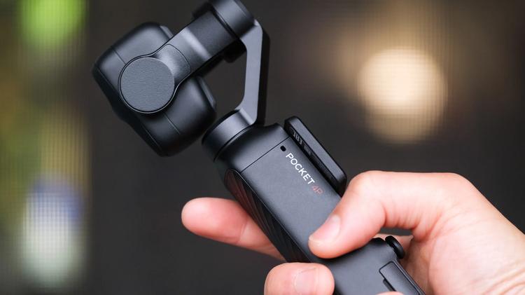 A side view of the DJI Osmo Pocket 4P in someone's hand.