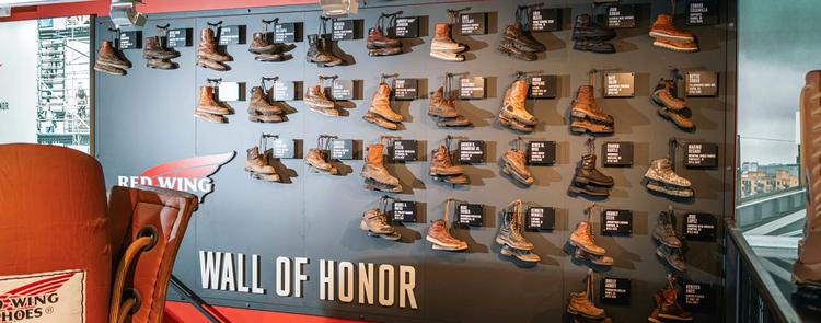 The Wall of Honor with all the honoree's boots hanging on the wall with their plaques next to them