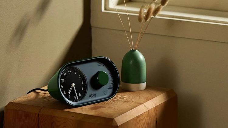 nanu arc alarm clock on nightstand next to vase